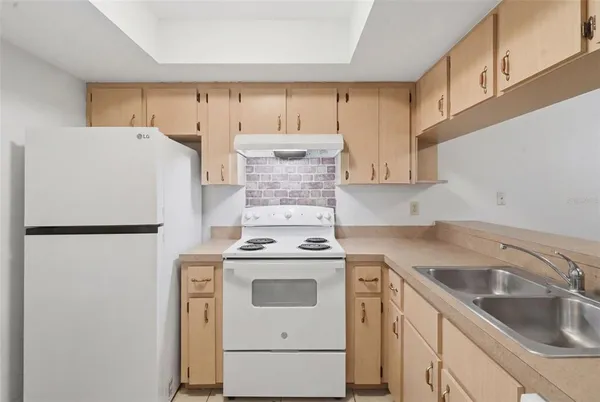 a white refrigerator freezer sitting inside of a kitchen