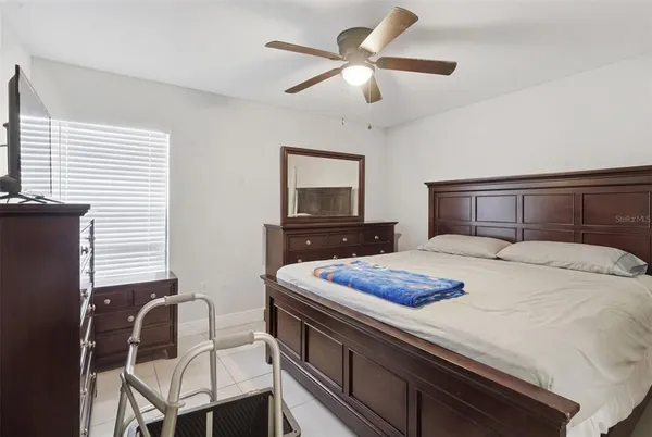 a bedroom with a bed and a chair