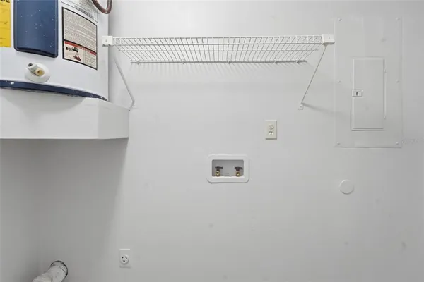 an empty room with windows and chandelier fan