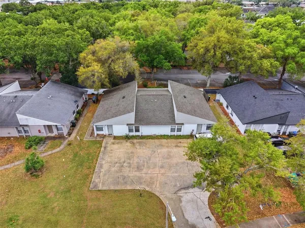 an aerial view of a house with a yard