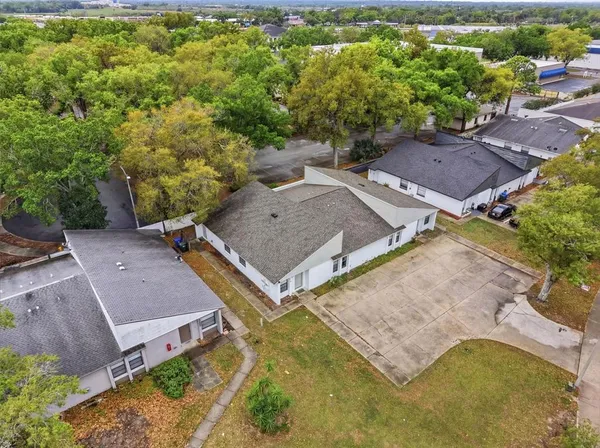 an aerial view of a house with a yard and lake view