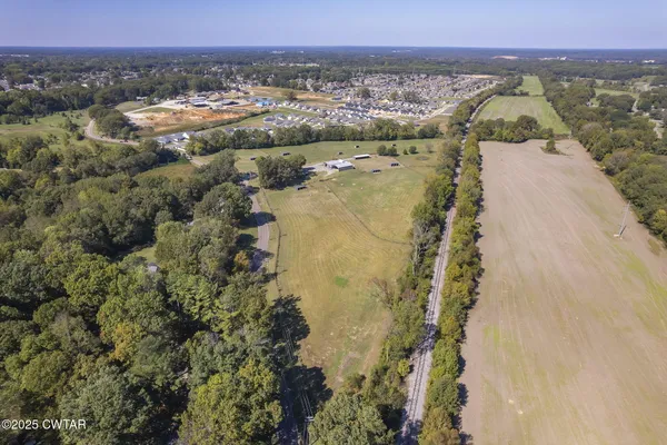 an aerial view of a houses with a yard