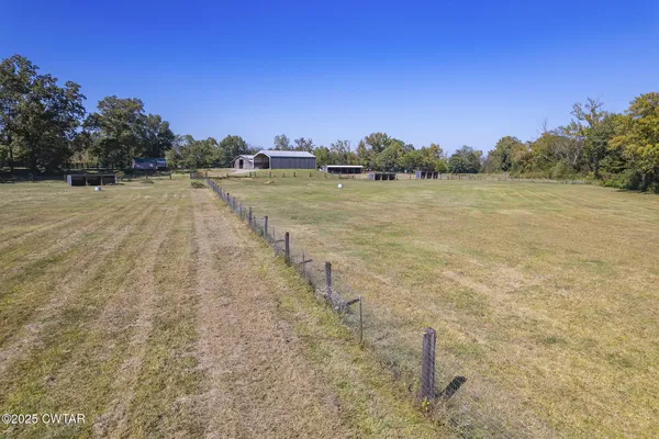 a view of a yard with a house in the background