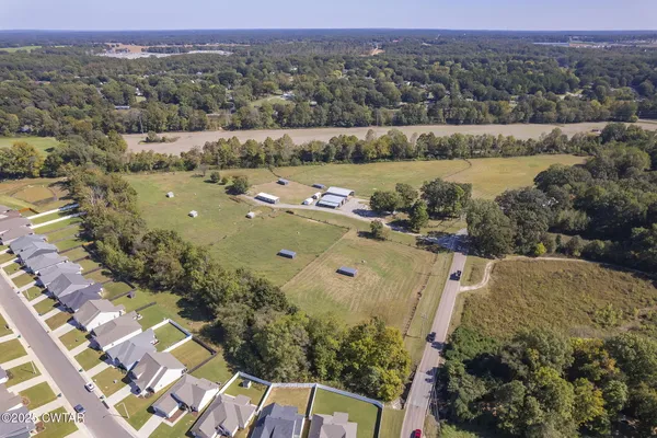 an aerial view of a houses with a yard