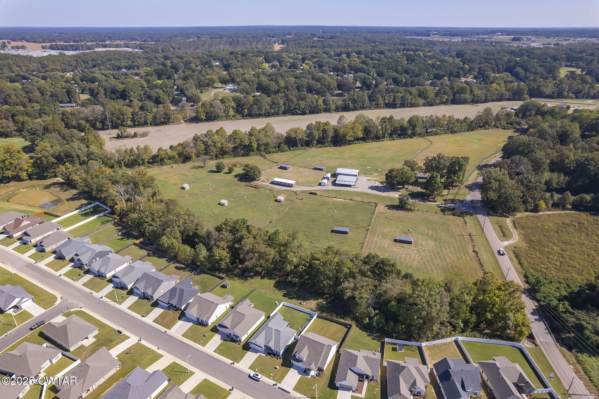 130 Cooper Anderson Road Jackson, TN 38305 - Photo 10 of 46 an aerial view of residential houses with outdoor space and river