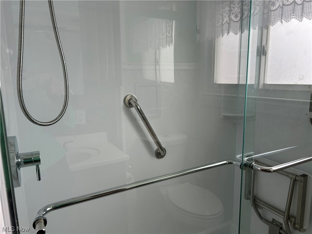 766 Bridge Road Akron, OH 44312 - Photo 13 of 34 Bathroom features an enclosed shower with fold-up sitting chair