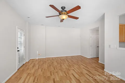 a view of empty room with wooden floor