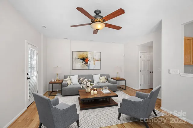 a living room with furniture and a ceiling fan