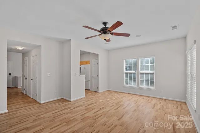 a view of a livingroom with a hardwood floor and a ceiling fan
