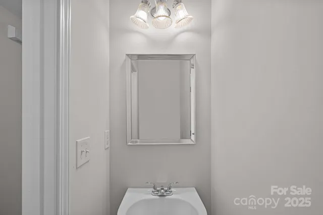 a bathroom with a sink a mirror and a window