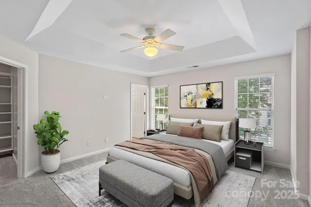 a bedroom with a bed and a potted plant