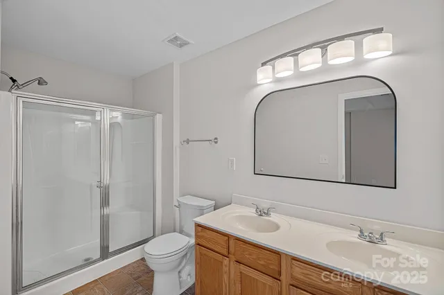 a bathroom with a toilet a sink and a mirror