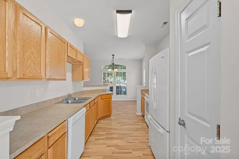 a kitchen with a sink stove and refrigerator