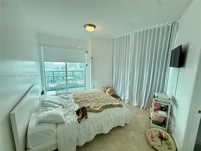 a bed sitting in a bedroom next to a window