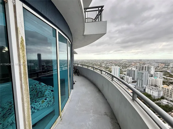 a view of a balcony with an outdoor seating