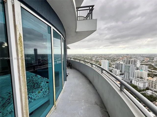 a view of a balcony with an outdoor seating