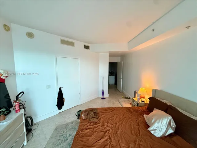 a bed room with a bed and a couch