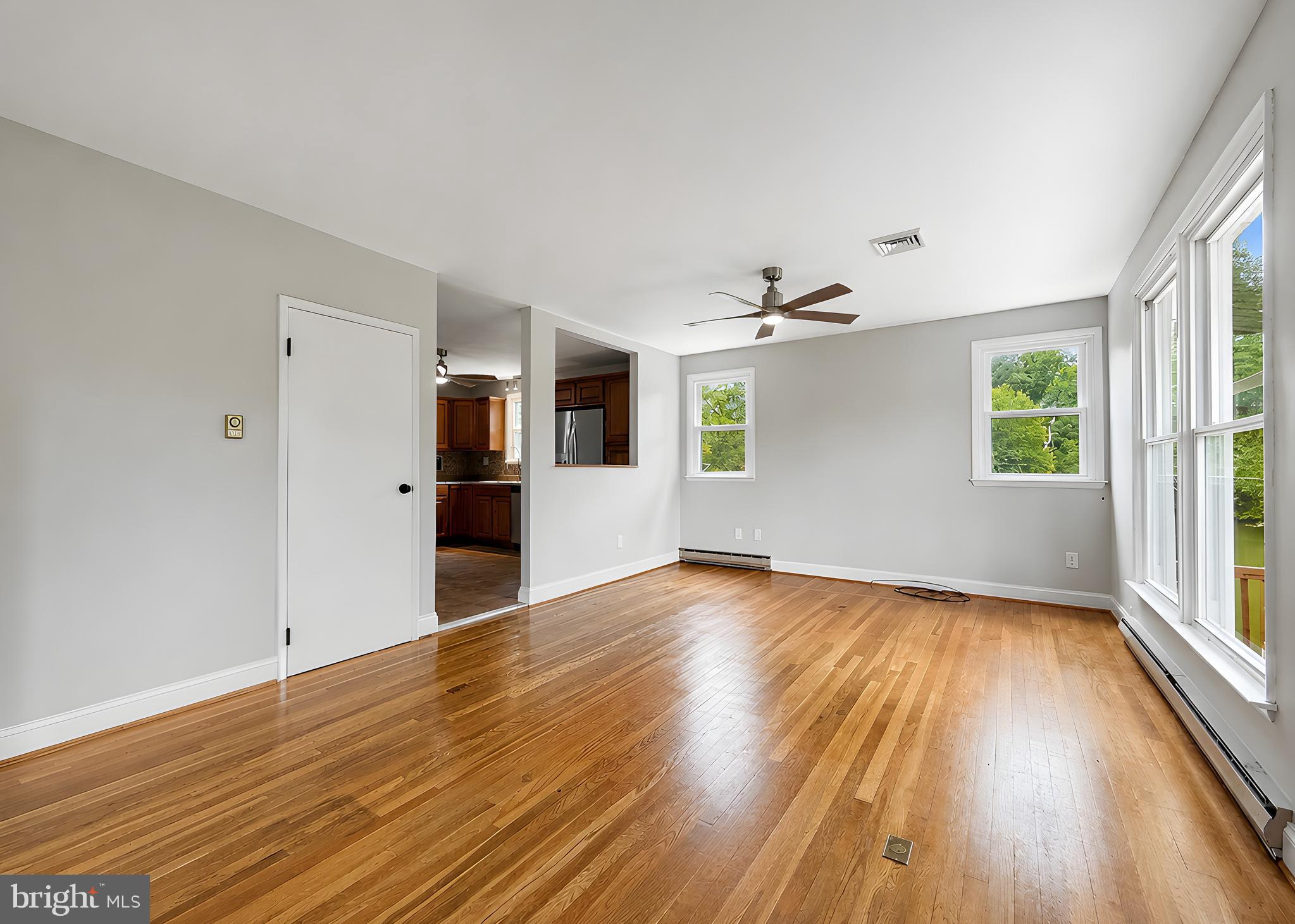 17248 Gum Landing Road St. Inigoes, MD 20684 - Photo 4 of 56 an empty room with wooden floor and windows