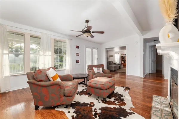 a living room with furniture and wooden floor