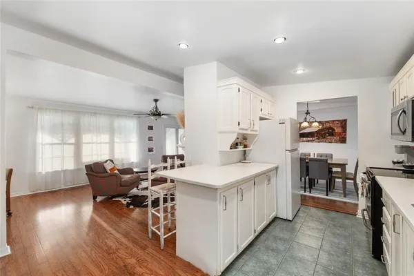 a large white kitchen with cabinets