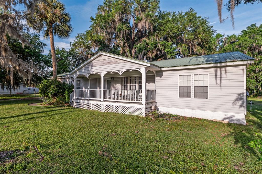20361 1st Street McIntosh, FL 32664 - Photo 6 of 62 a front view of a house with a garden