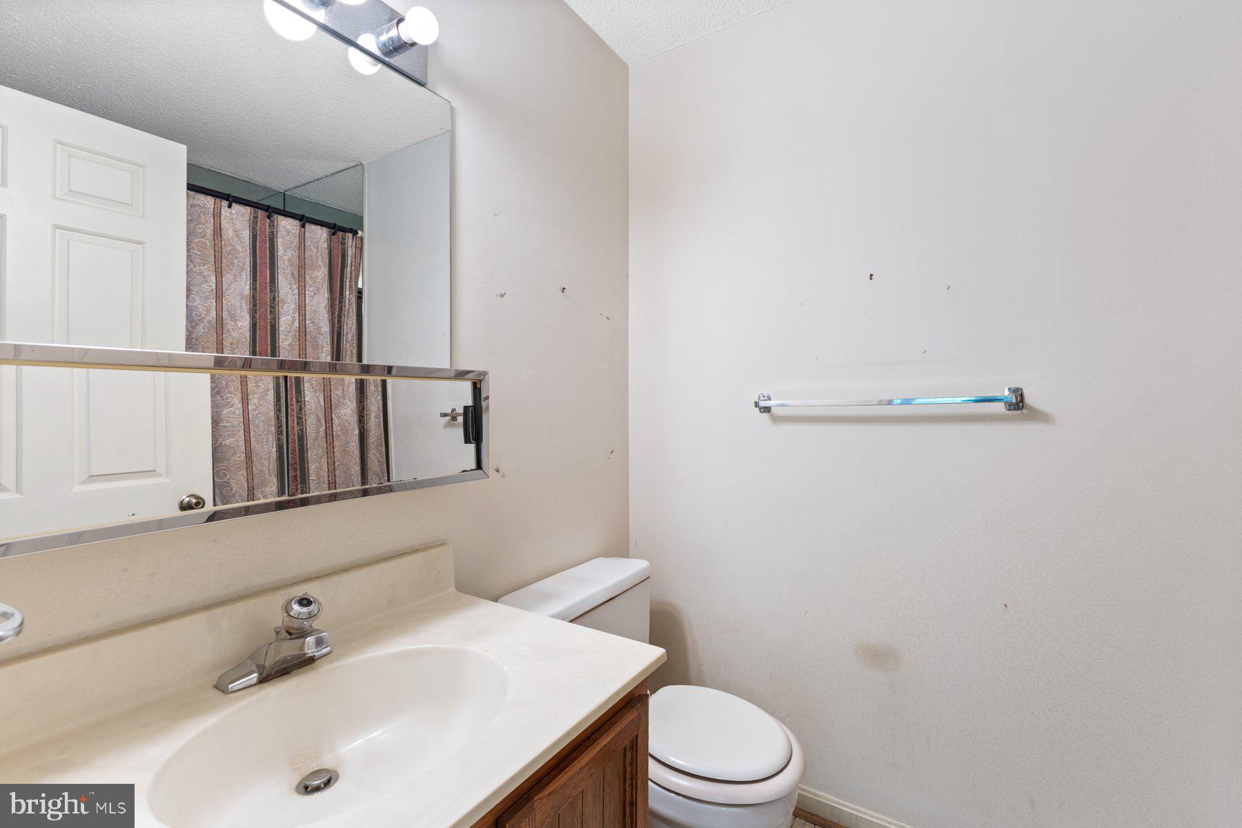 11337 Baroque Road Silver Spring, MD 20901 - Photo 20 of 29 a bathroom with a sink a toilet and mirror