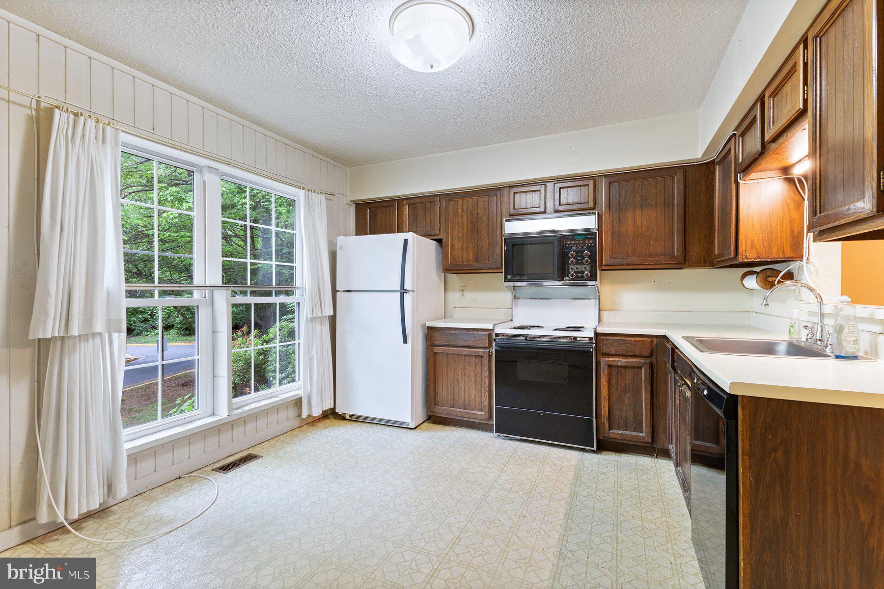 11337 Baroque Road Silver Spring, MD 20901 - Photo 2 of 29 a kitchen with a refrigerator and a sink