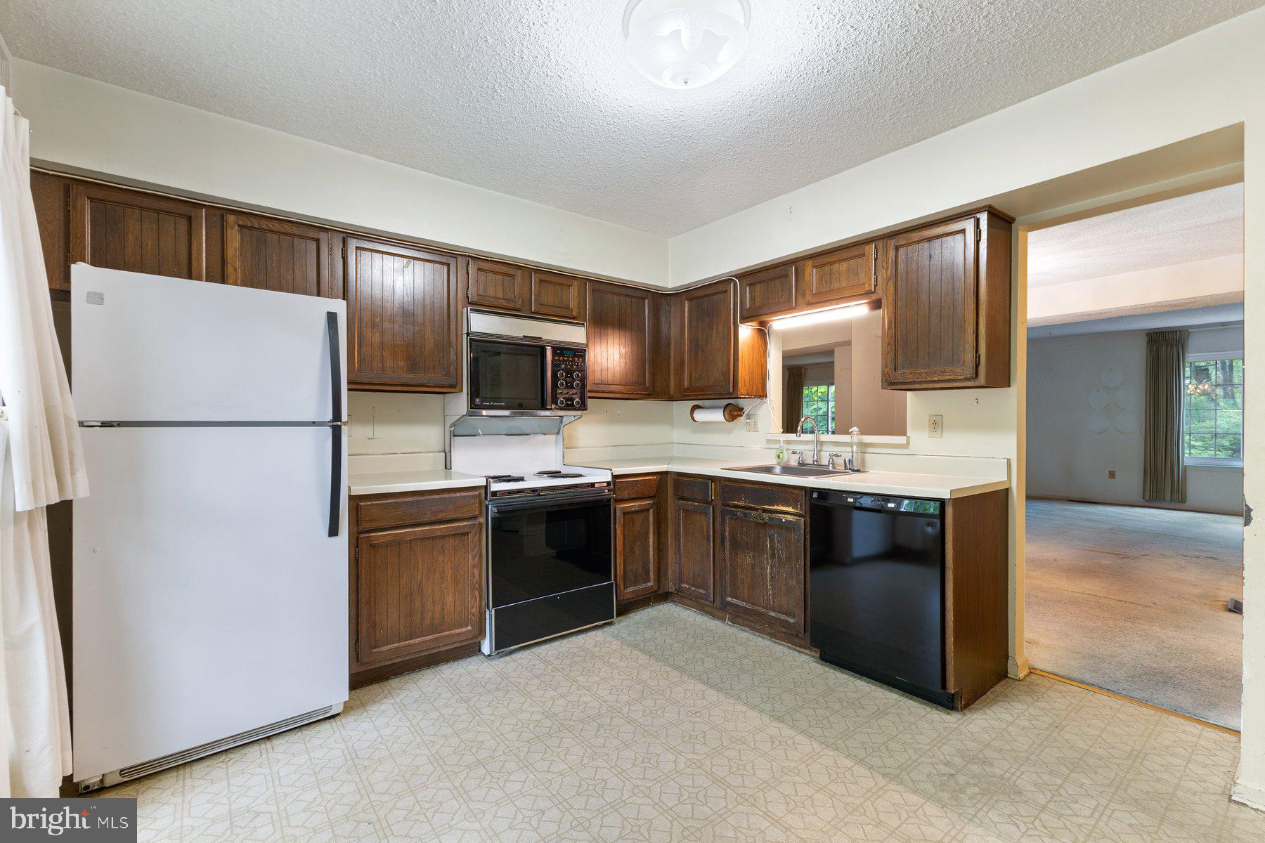 11337 Baroque Road Silver Spring, MD 20901 - Photo 3 of 29 a large kitchen with cabinets and stainless steel appliances
