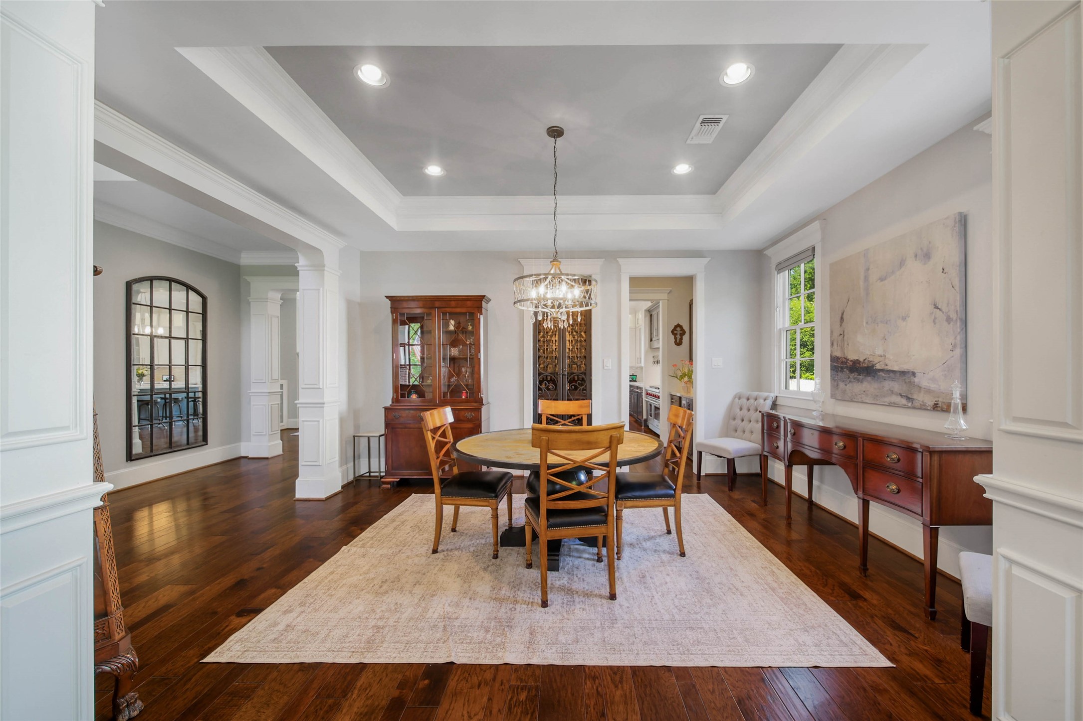 416 West 33rd Street Houston, TX 77018 - Photo 15 of 47 Elegant formal dining room perfectly positioned just off the kitchen and connected through a well-appointed Butler’s Pantry, creating an effortless flow for entertaining. Rich hardwood floors, striking coffered ceilings, beautifully encased windows and extensive custom millwork throughout the foyer and dining spaces add warmth, sophistication and timeless architectural character.