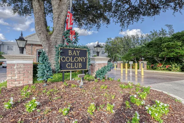 a sign board with buildings in the background