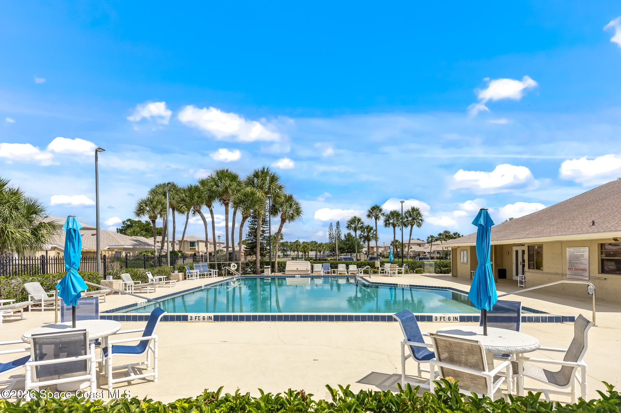 1411 Sheafe Avenue Northeast, Unit 101 Palm Bay, FL 32905 - Photo 21 of 24 a swimming pool with outdoor seating and yard