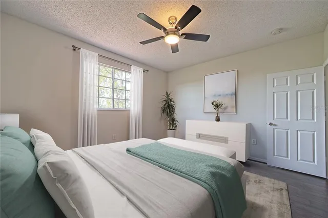 a view of a park with of a house in the background