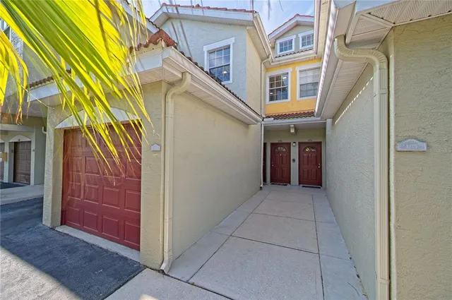 an empty room with wooden floor chandelier fan and windows