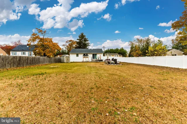 a view of a large pool with an outdoor space and seating area