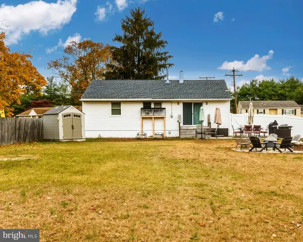a view of a house with swimming pool and sitting area