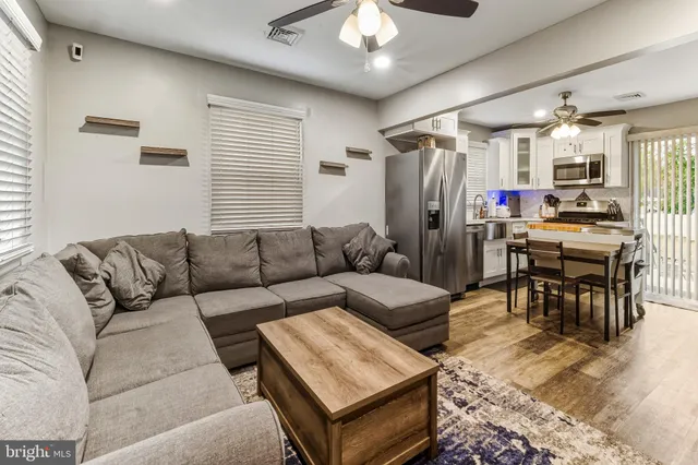 a living room with furniture and a chandelier