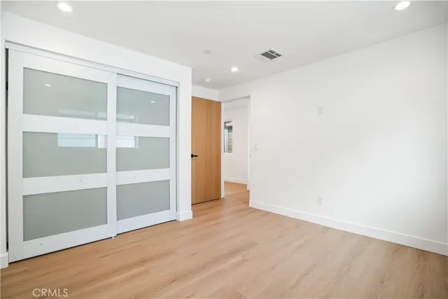 an empty room with wooden floor