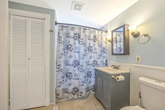 a bathroom with a toilet a sink and a shower