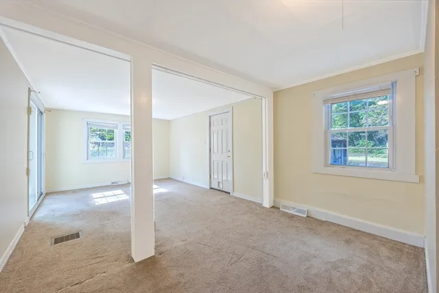 an empty room with windows and closet