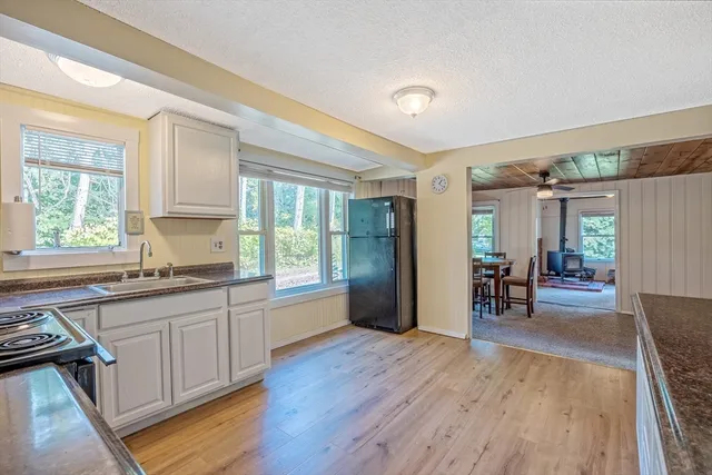 a open kitchen with sink and cabinets