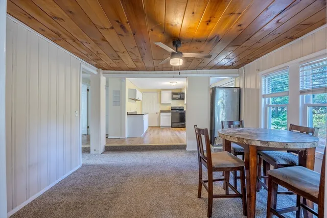a dining room with furniture a chandelier and a rug