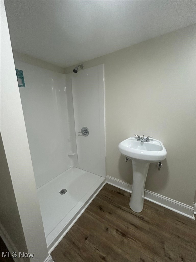 15410 Turney Road Maple Heights, OH 44137 - Photo 32 of 46 Bathroom featuring a stall shower and dark wood-style floors