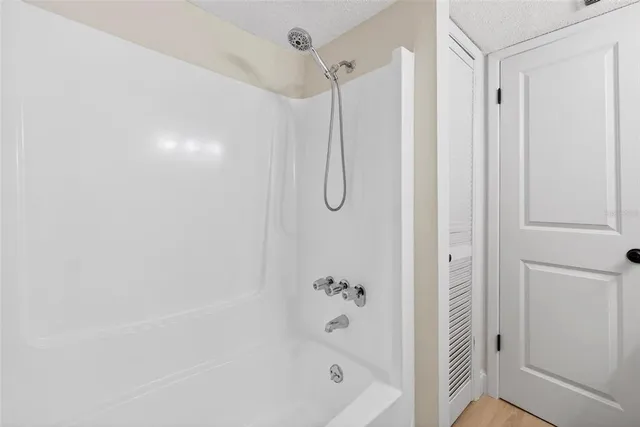 a bathroom with a shower and a glass door