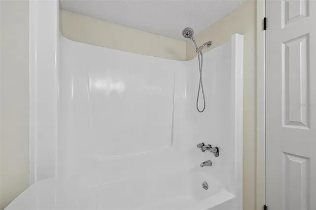 a bathroom with a glass shower door