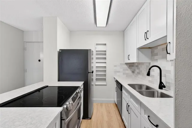 a kitchen with granite countertop a stove and a sink