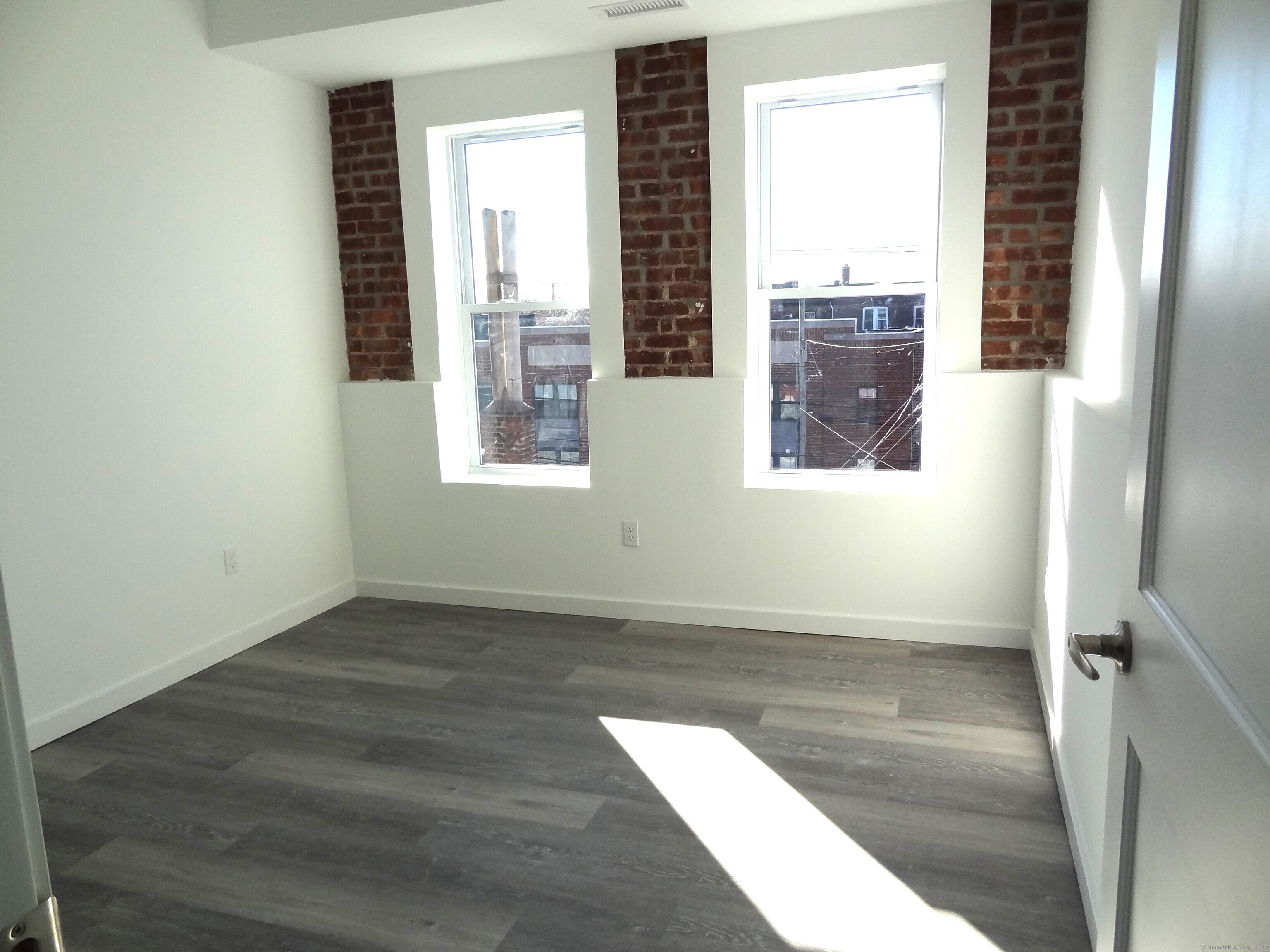 2806 Fairfield Avenue, Unit 307 Bridgeport, CT 06605 - Photo 8 of 24 an empty room with windows