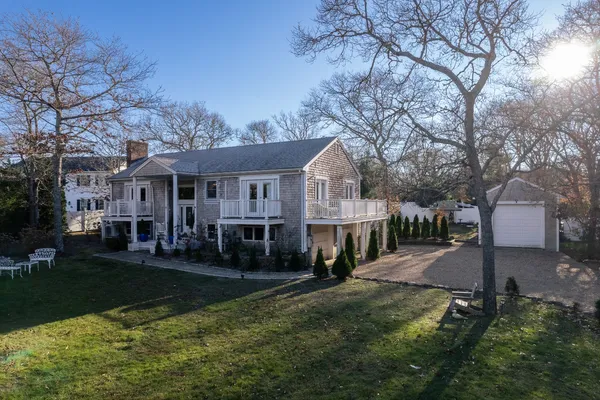 a view of house with a yard