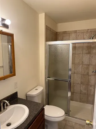 a bathroom with a toilet a sink and shower