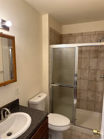 a bathroom with a toilet a sink and shower