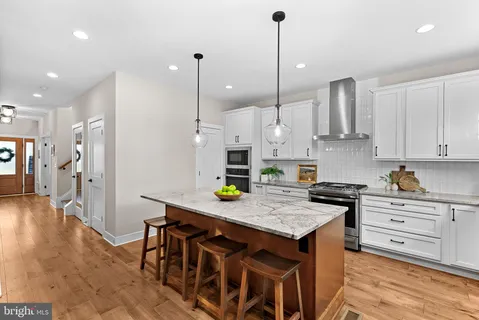 a kitchen with a table chairs sink and cabinets